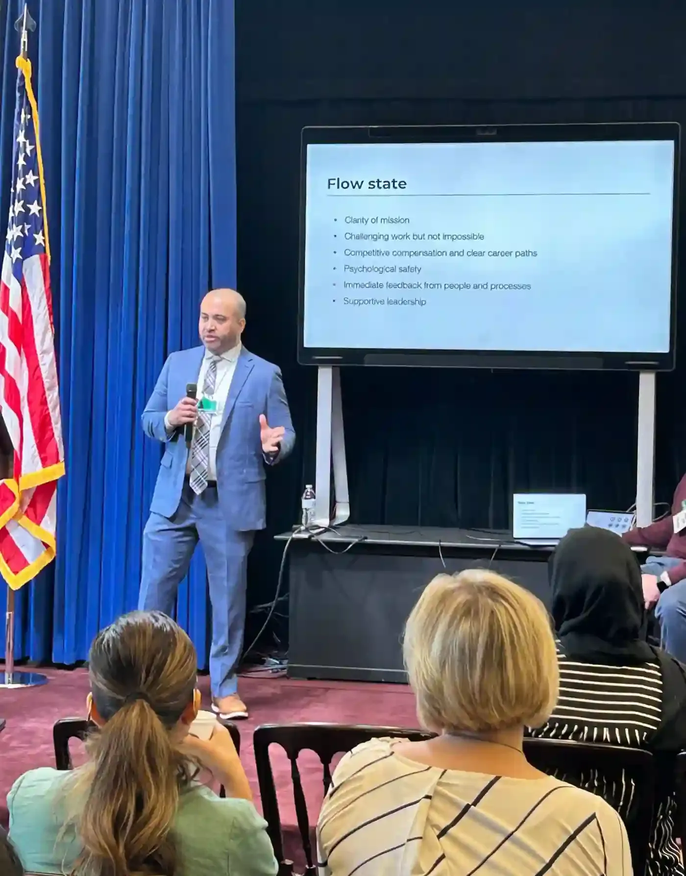 Neil Chaudhuri presenting flow state on a slide to the audience.